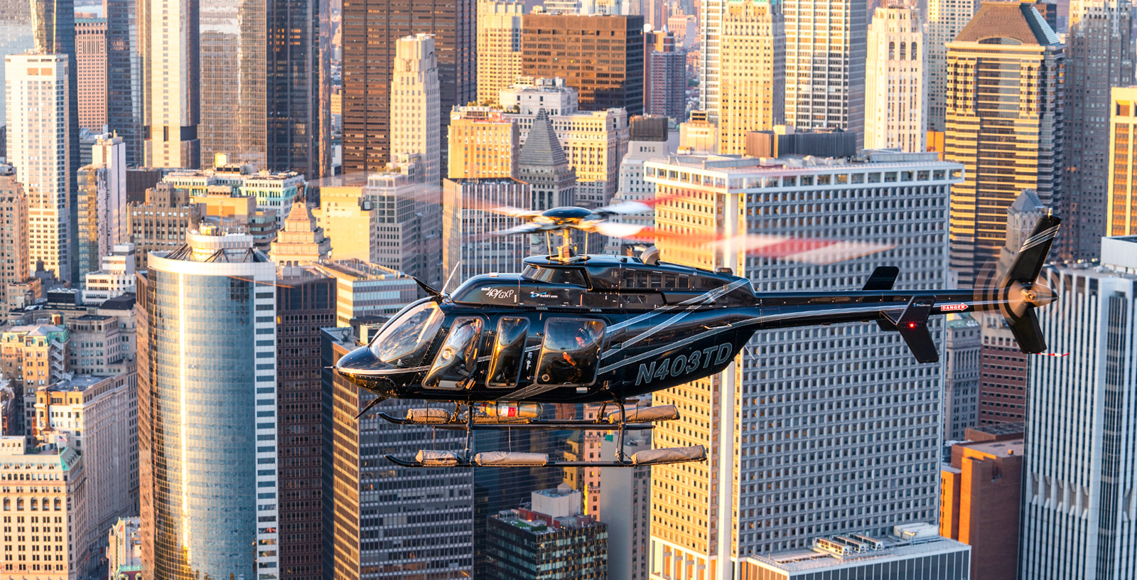 Helicopter flying over New York City skyline during a tour.