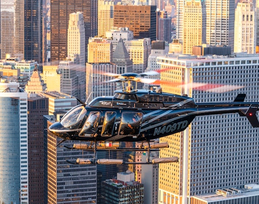 Helicopter flying over New York City skyline during a tour.