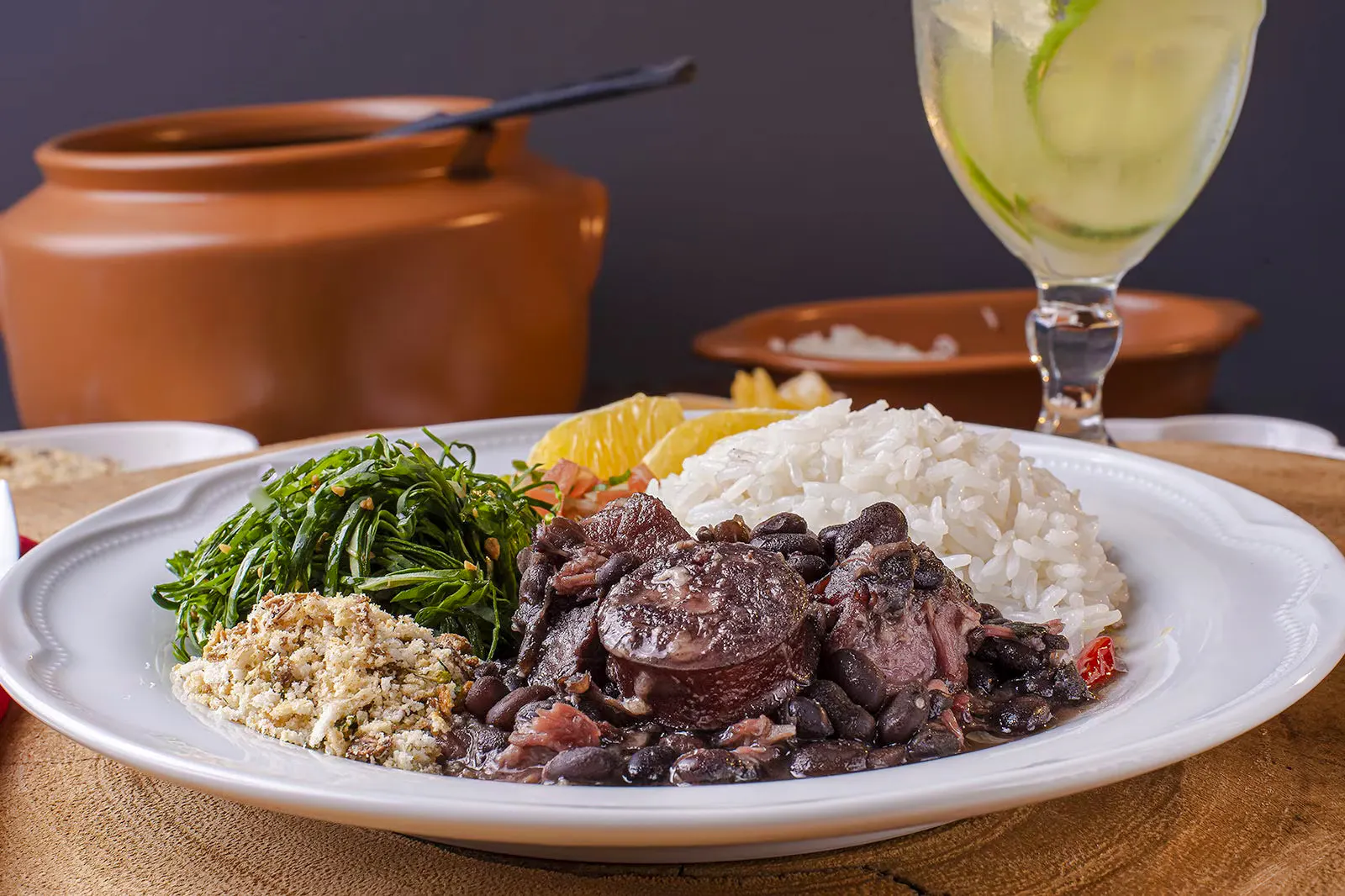Authentic Brazilian feijoada with rice, greens, and orange slices in Rio de Janeiro.