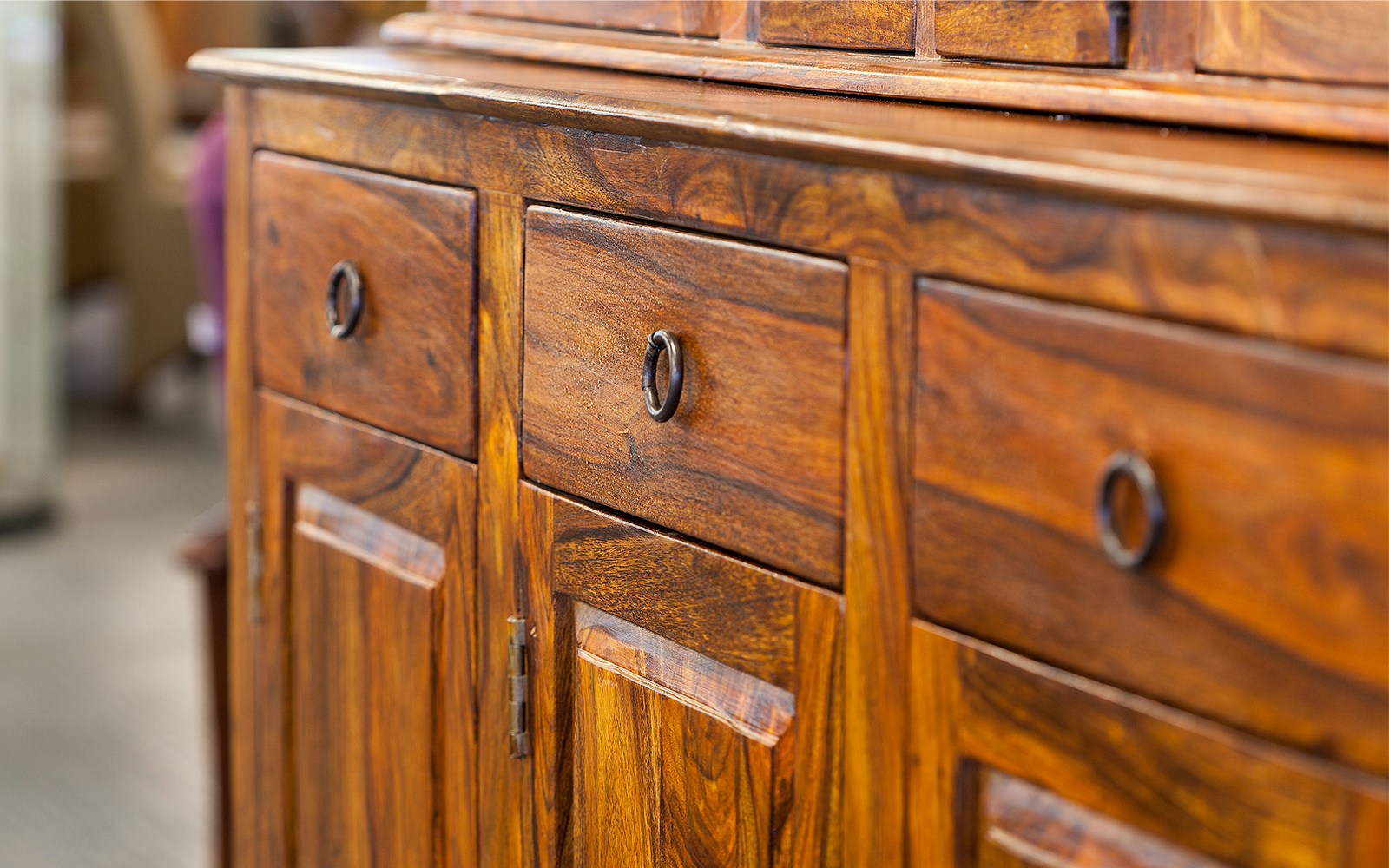 Wooden cabinet with drawers and metal handles.