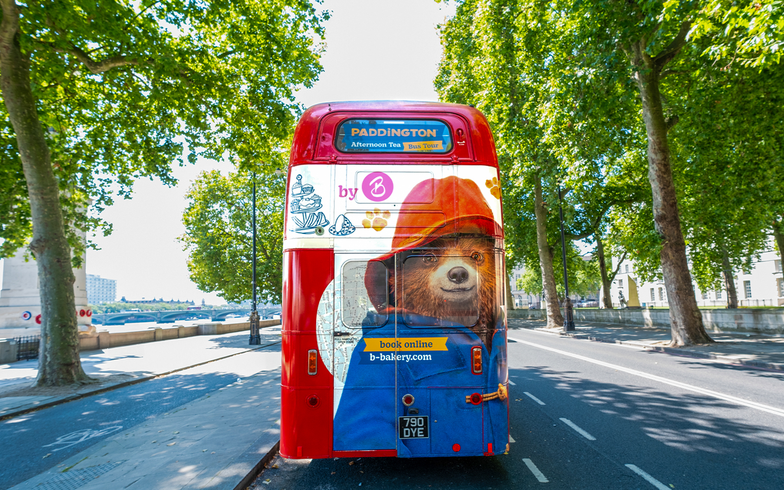 Red double-decker bus with Paddington Bear design for Brigit's Bakery Afternoon Tea tour in London.