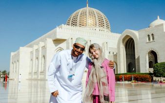 Tourists at Sultan Qaboos Grand Mosque, Muscat, during city highlights tour.