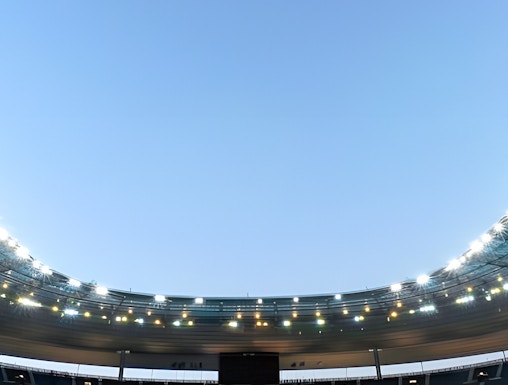 Stade de France in Paris with empty seats and illuminated roof.