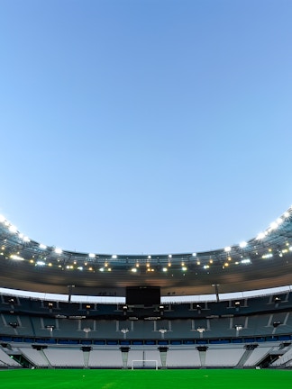 Stade de France in Paris with empty seats and illuminated roof.