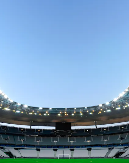 Stade de France in Paris with empty seats and illuminated roof.