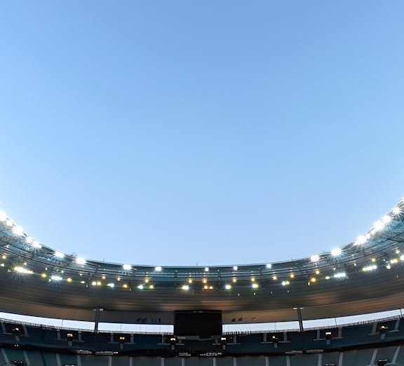 Stade de France in Paris with empty seats and illuminated roof.