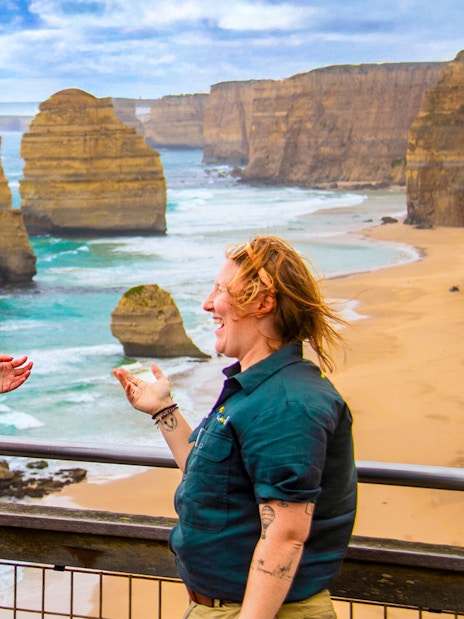 Tourists enjoying the view of the 12 Apostles on a Great Ocean Road guided tour.