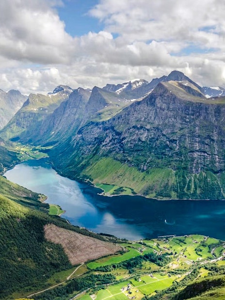 Aerial view of Hjørundfjord with surrounding mountains and water, Norway.