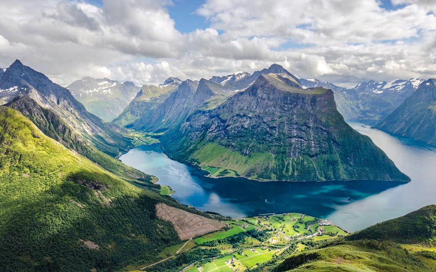 Aerial view of Hjørundfjord with surrounding mountains and water, Norway.