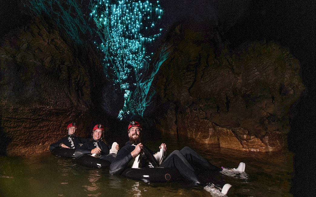 Guided black water rafting under glowworms in Waitomo cave.