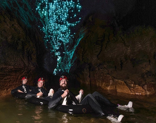 Guided black water rafting under glowworms in Waitomo cave.
