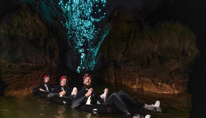 Guided black water rafting under glowworms in Waitomo cave.