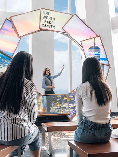 Visitors listening to a guide at One World Observatory, New York City.