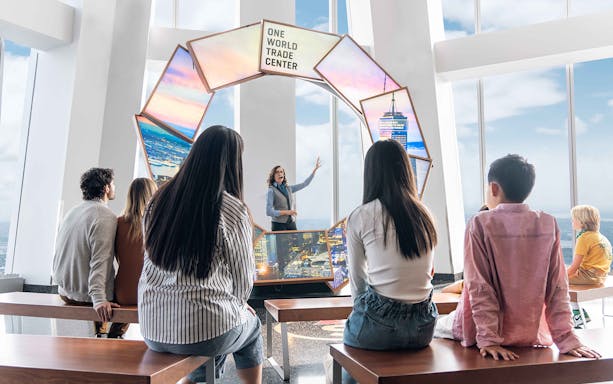 Visitors listening to a guide at One World Observatory, New York City.
