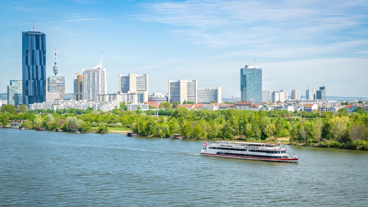 Danube River cruise in Vienna with passengers enjoying brunch and live music on a sunny day.