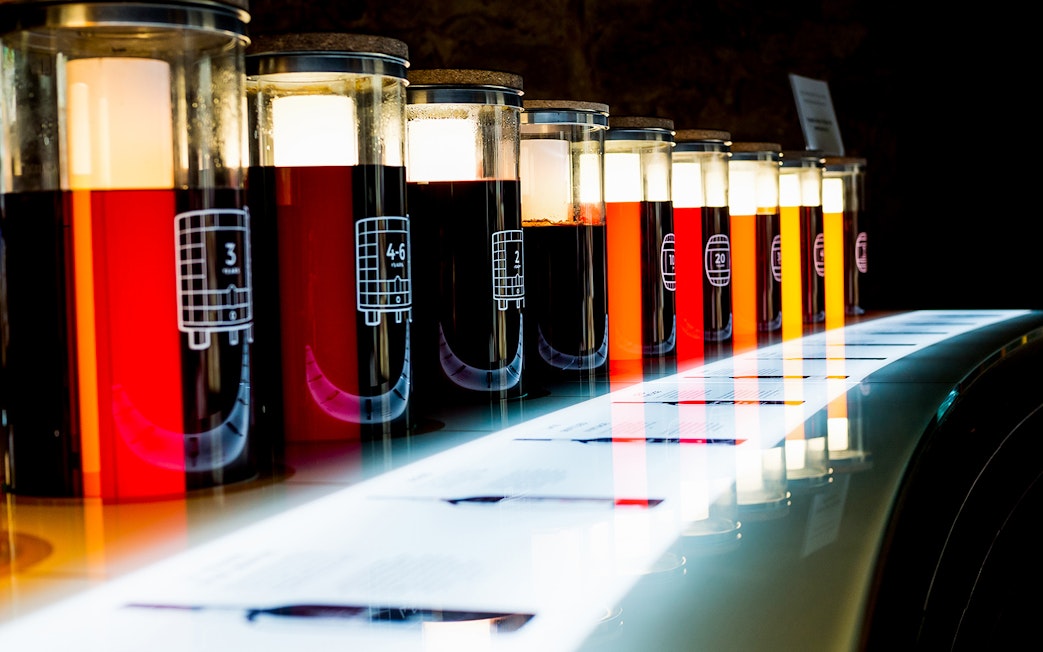 Wine aging barrels at Cálem Cellars during guided tour and tasting in Porto.