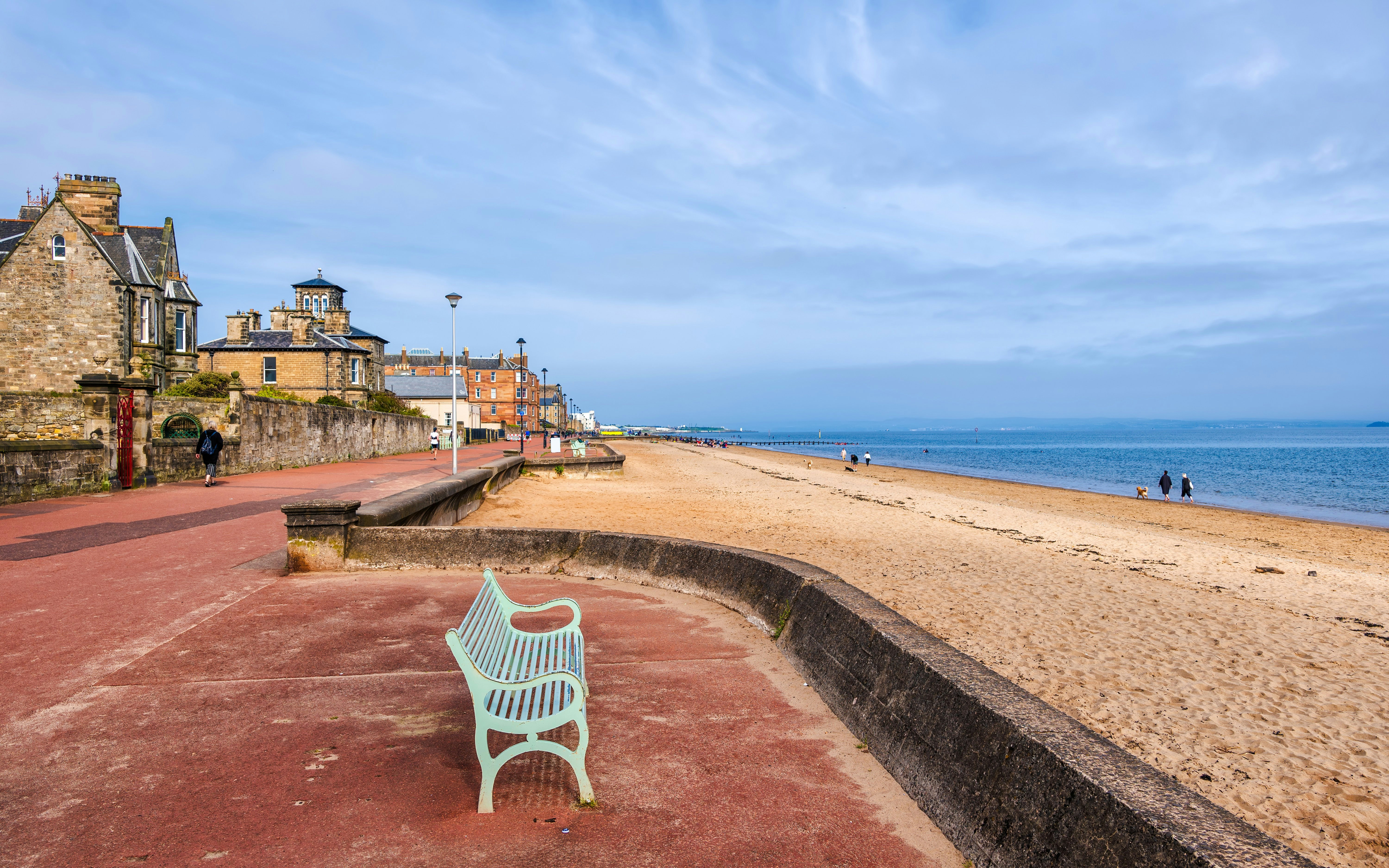 Portobello Beach promenade with benches and historic buildings in Edinburgh, Scotland.