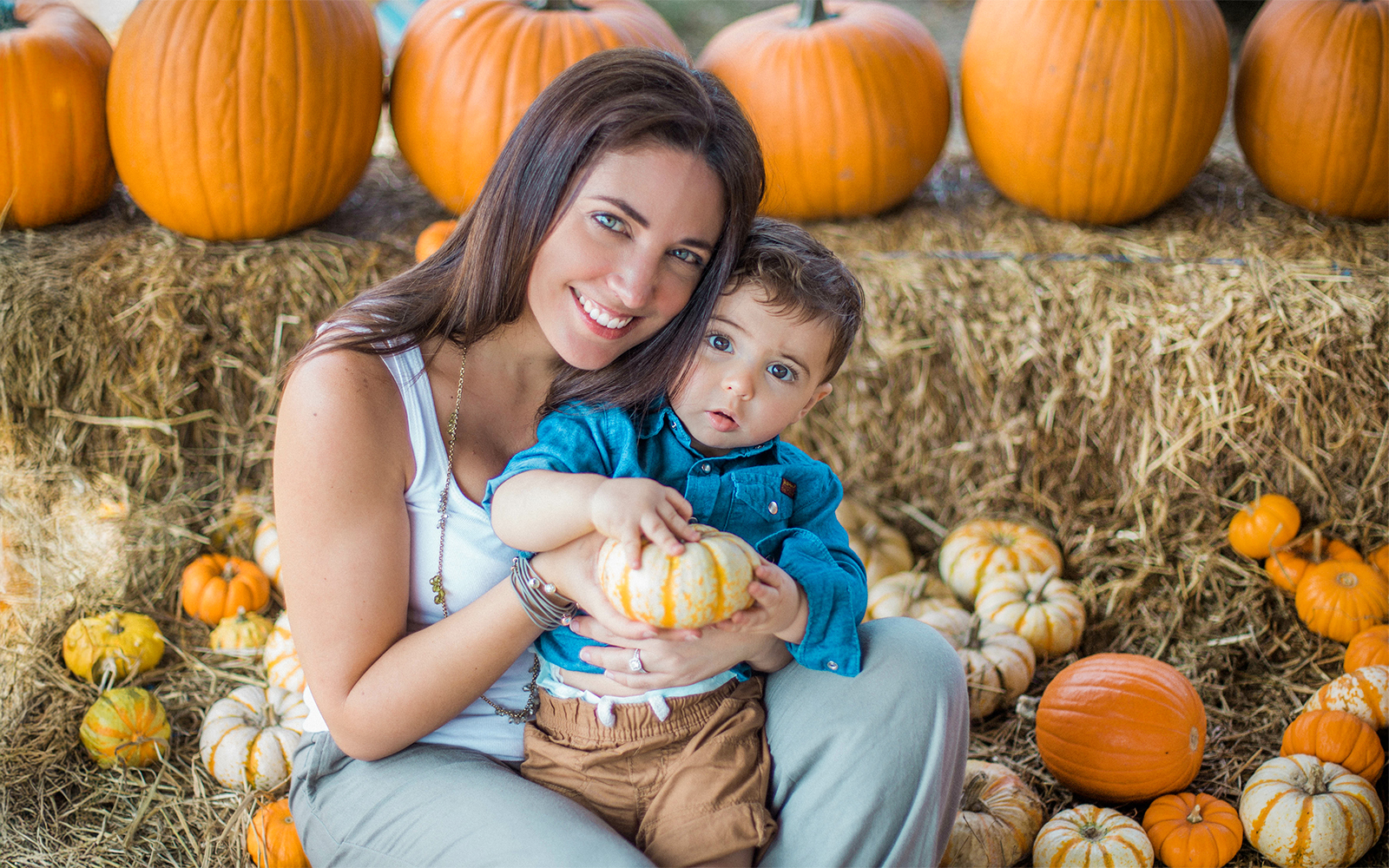 Mom and son picking pumpkins at a patch in central Florida, Orlando.