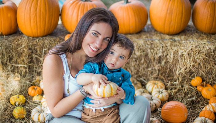 Mom and son picking pumpkins at a patch in central Florida, Orlando.