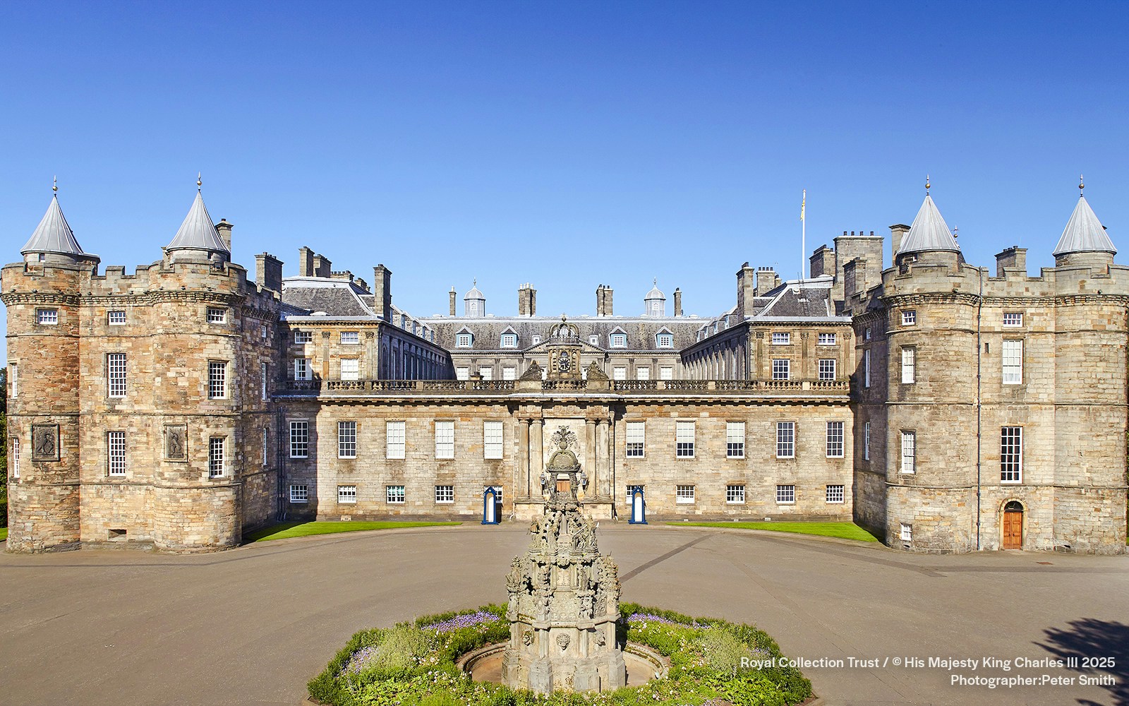 Palace of Holyroodhouse exterior with central fountain, Edinburgh, Scotland.