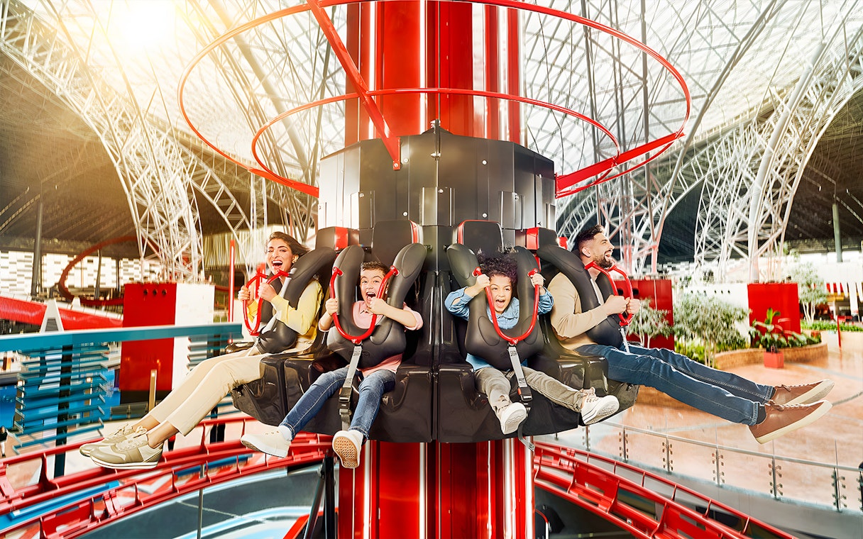 Visitors enjoying a thrilling ride at Ferrari World, Dubai theme park.