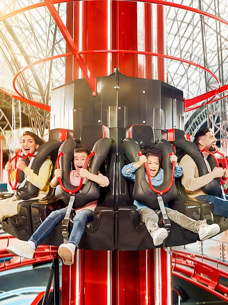 Visitors enjoying a thrilling ride at Ferrari World, Dubai theme park.
