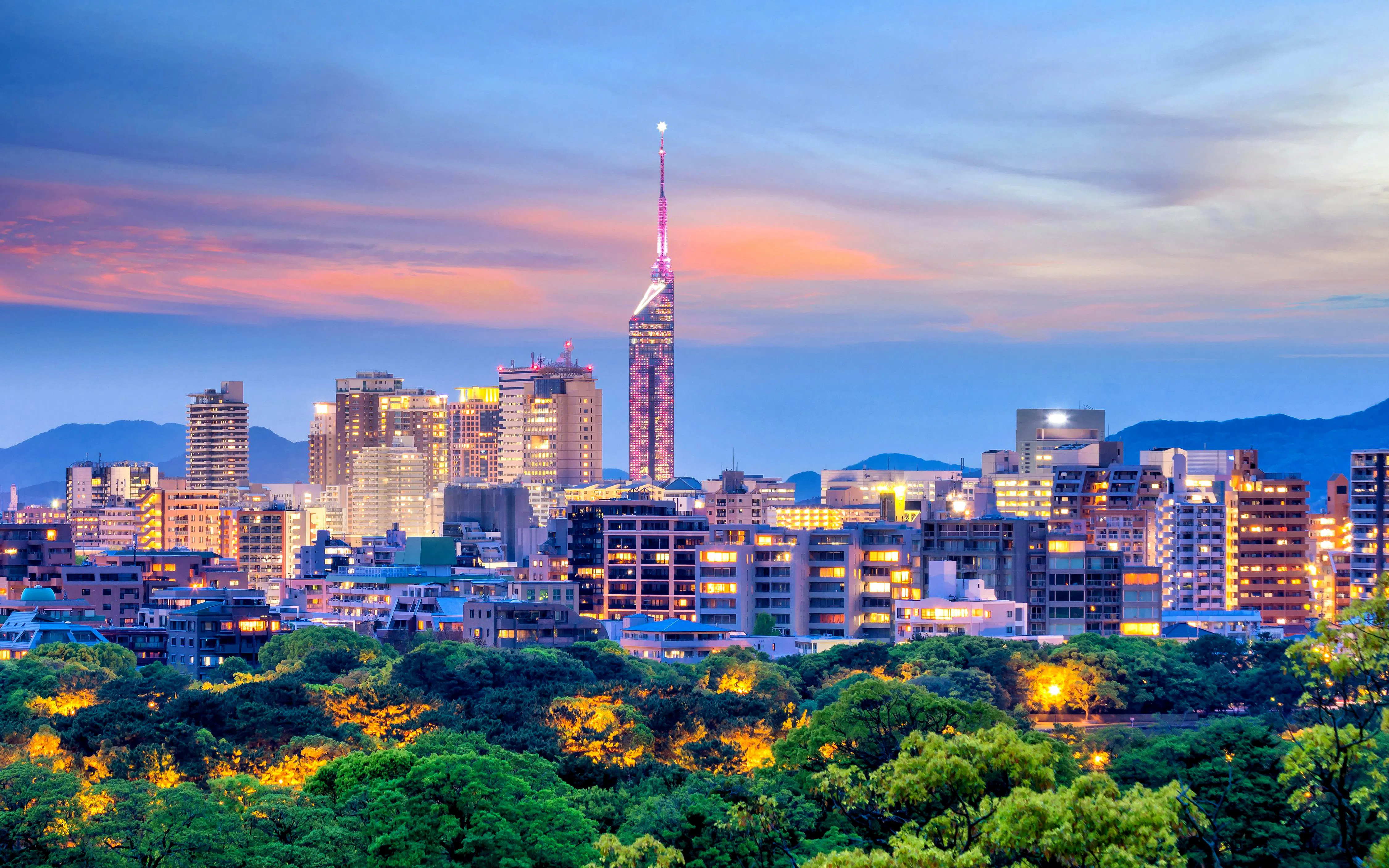 Fukuoka City skyline at dusk with Fukuoka Tower, Japan.