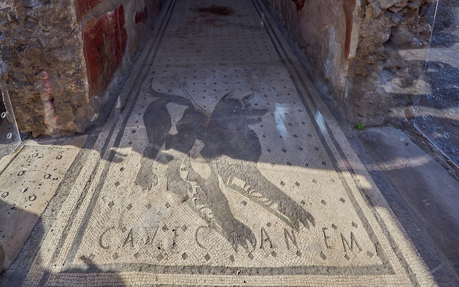Cave canem (beware of the dog) Roman mosaic at the entrance to the house of the tragic poet in Pompeii, Italy