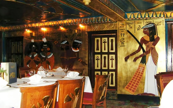 Dining area with Egyptian-themed decor on a Nile dinner cruise in Cairo.