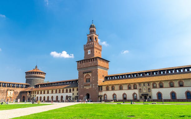 Sforza Castle battlements walkway in Milan under a clear blue sky.