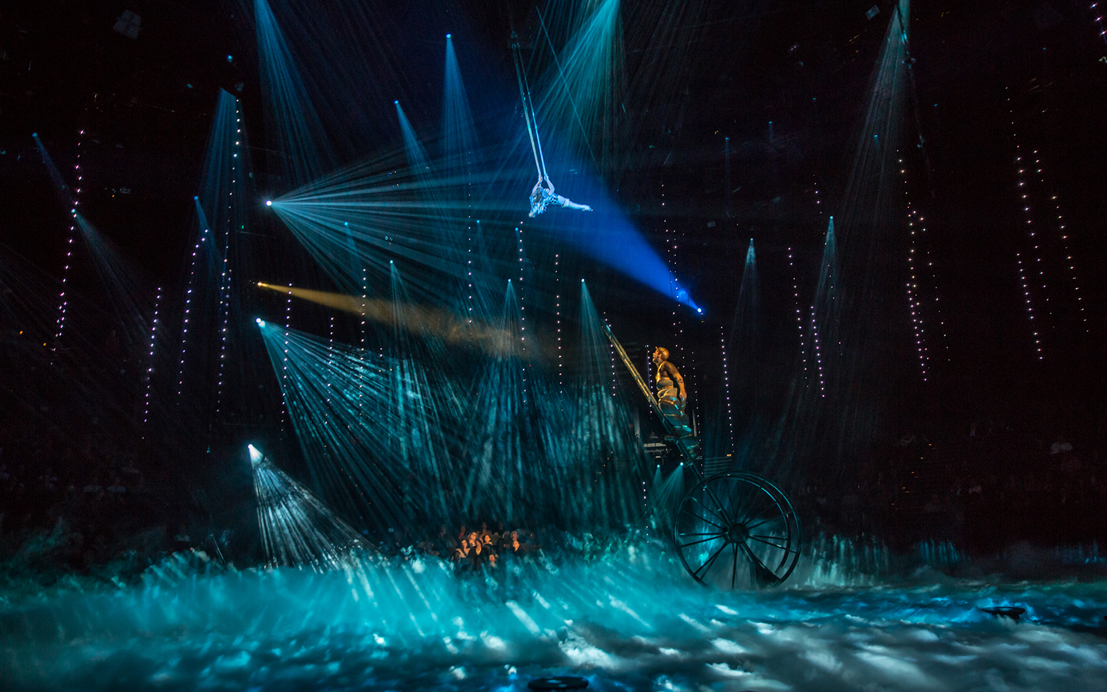 Acrobat performing above stage with blue lights at The Beatles LOVE show.