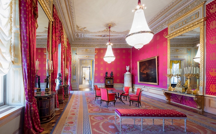 Habsburg State Rooms with ornate chandeliers, red drapes, and elegant furnishings.