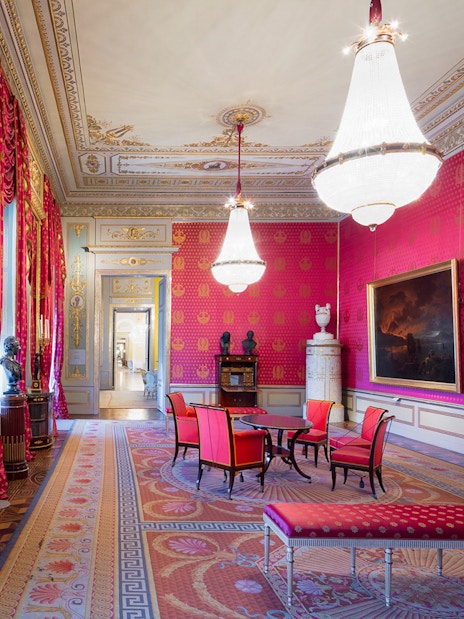 Habsburg State Rooms with ornate chandeliers, red drapes, and elegant furnishings.