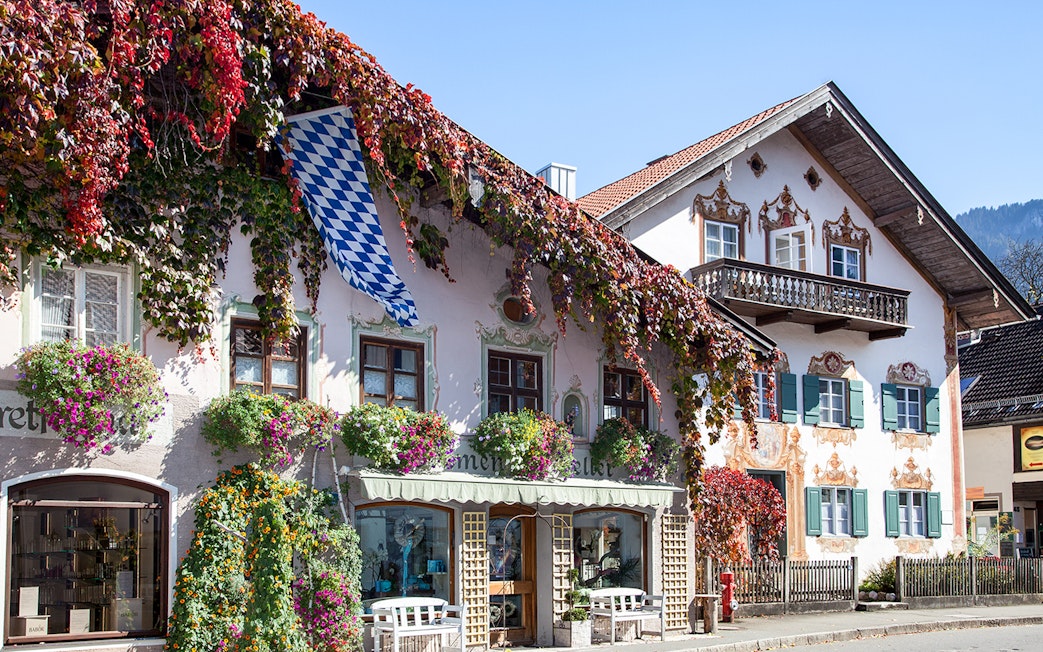 Bavarian house with painted facade and flowers in Oberammergau, Germany.