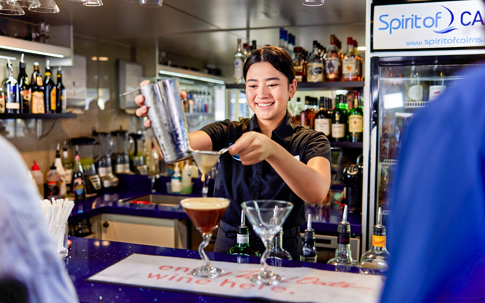 Bartender preparing a cocktail on Spirit of Cairns dinner cruise in Australia.