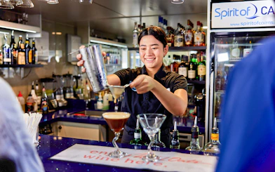 Bartender preparing a cocktail on Spirit of Cairns dinner cruise in Australia.