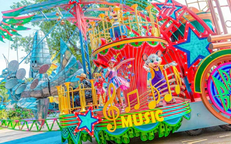 Colorful parade float with performers and characters at Chimelong Paradise.