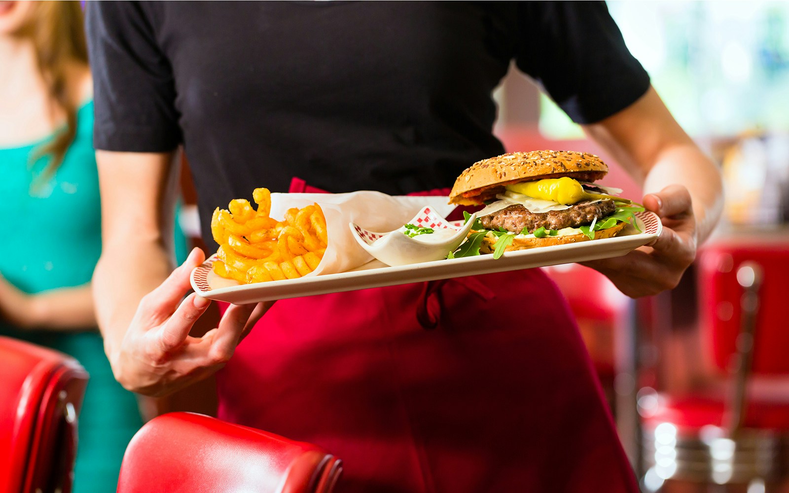 waiter serving american cheeseburger at disneyland paris