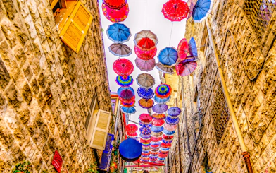 Colorful umbrellas hanging above an alley in old Amman, Jordan.