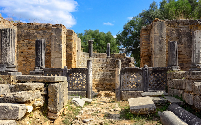 Ancient ruins with columns at Olympia, Greece, part of the archaeological tour from Katakolo.