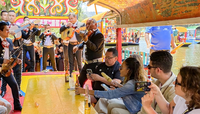 Guests on Trajinera Party boat enjoying live music in Xochimilco, Mexico City.