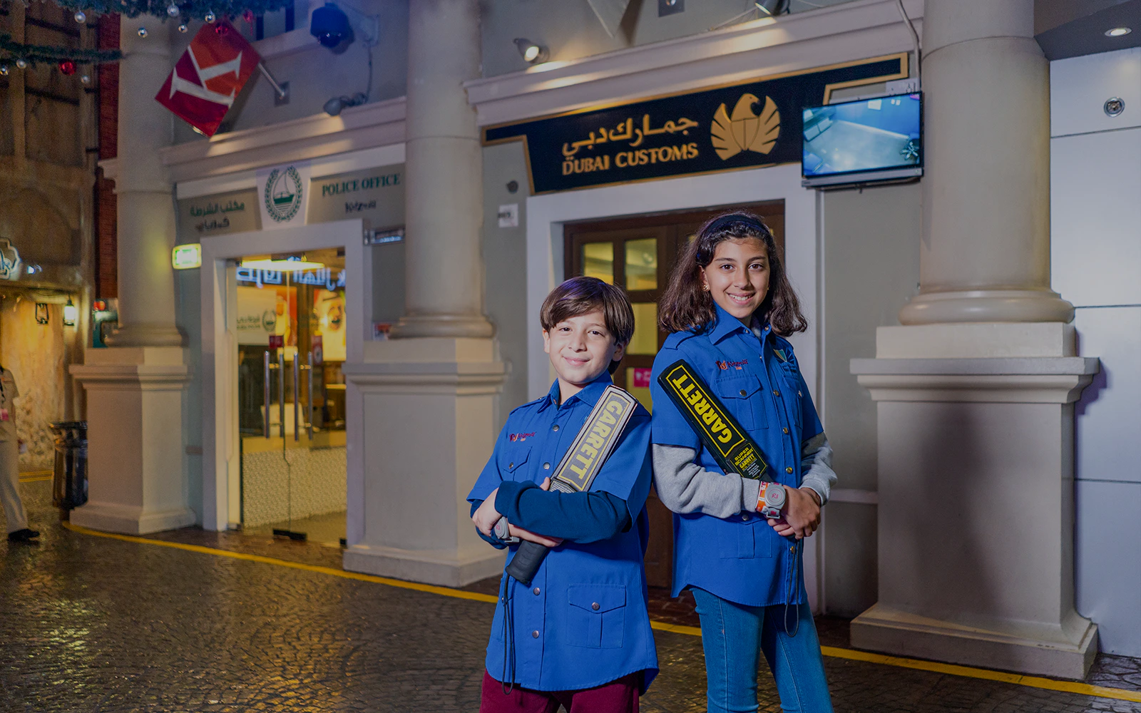 Children in security uniforms at KidZania Dubai near Dubai Customs exhibit.