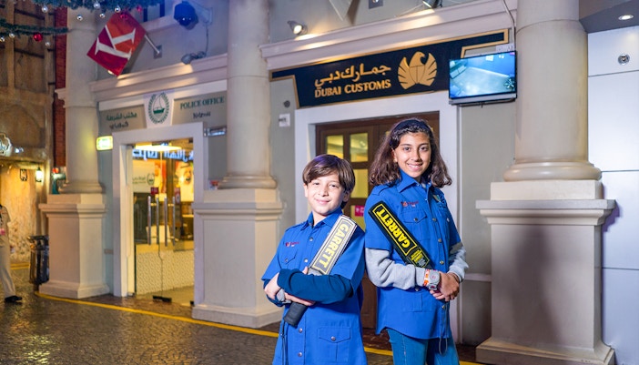 Children engaging in business and finance role-play activities at KidZania Abu Dhabi indoor theme park.