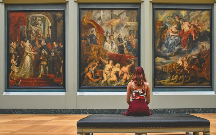 Guest viewing paintings inside Kunsthistorisches Museum Vienna.