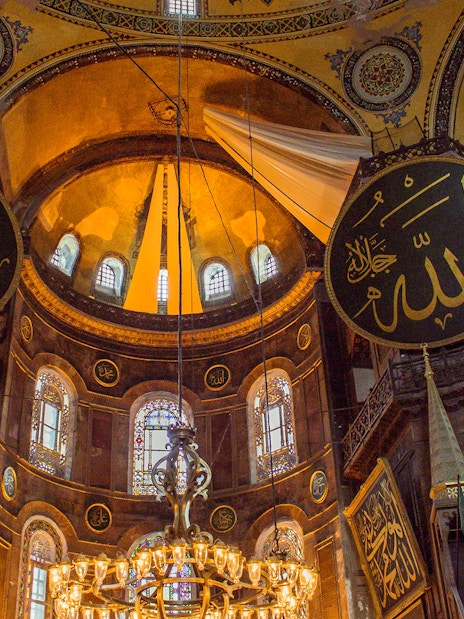 Hagia Sophia interior with ornate dome and Islamic calligraphy, Istanbul.