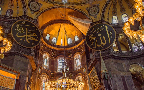 Hagia Sophia interior with ornate dome and Islamic calligraphy, Istanbul.