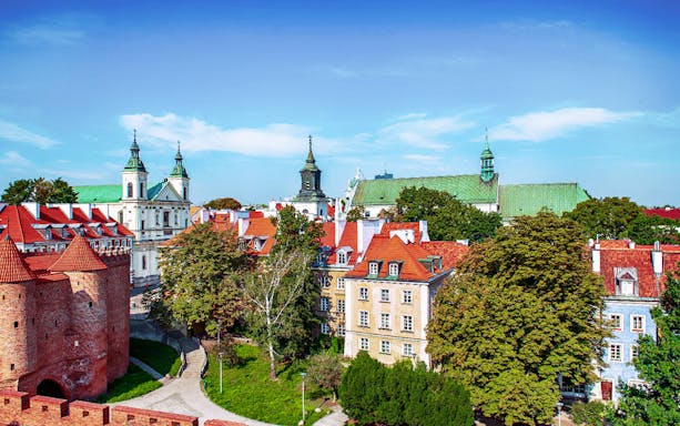 Warsaw Old Town with Barbican and historic buildings on a sunny day.