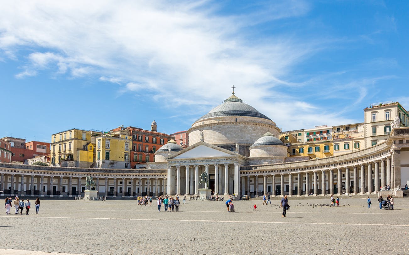 Plebiscito Square in Naples with Basilica and people walking.