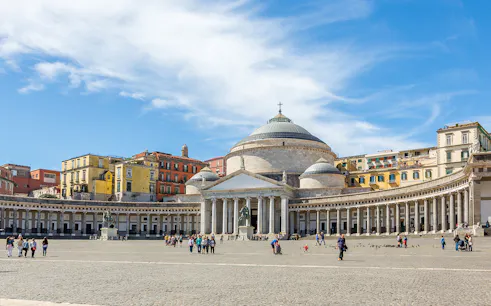 Plebiscito Square in Naples with Basilica and people walking.