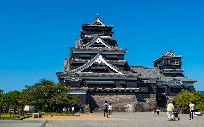 Kumamoto Castle with visitors walking in the courtyard, Kumamoto, Japan.